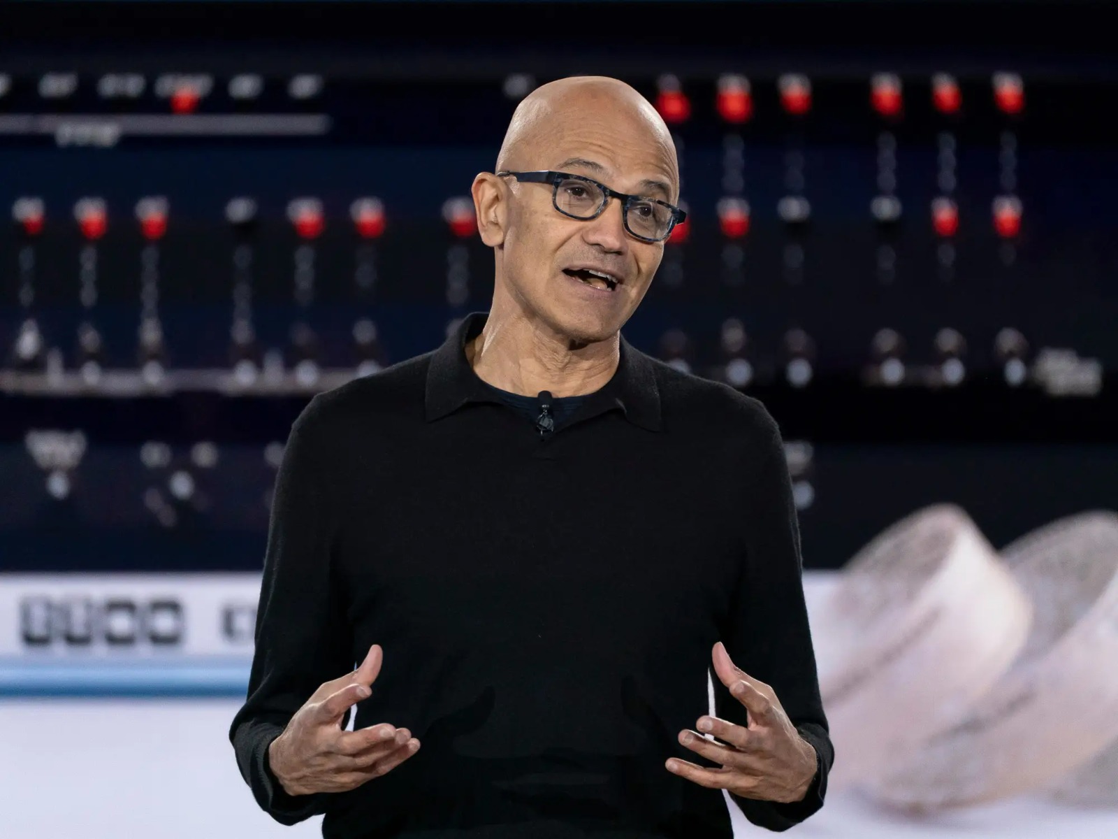 Black and white photo of fashionable black woman posing seductively on the floor with Chanel handbag